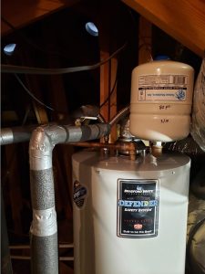 photo of water heater with expansion tank attached in attic